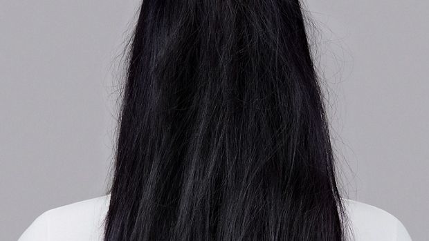 Model with long wavy brunette hair.