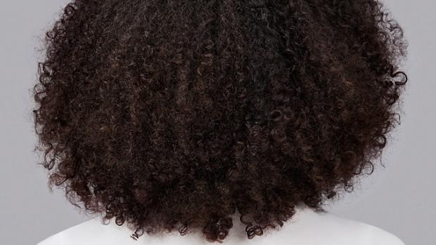 Model with coily brown hair.