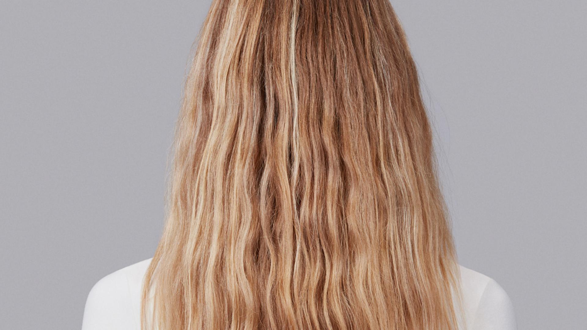 Model with long wavy blonde hair.