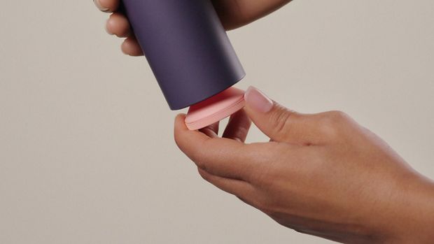 Unscrewing the reusable pump from the outer sleeve.