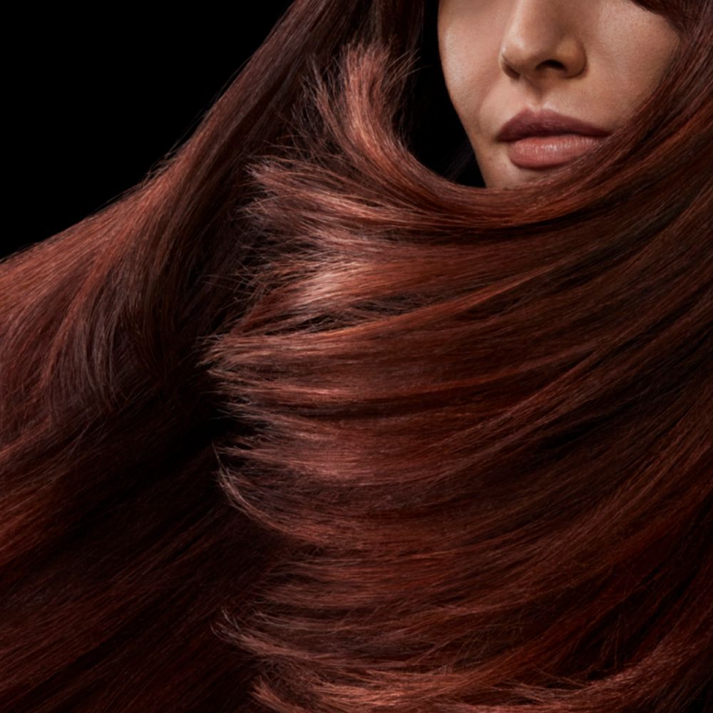 A model with long shiny brunette hair.