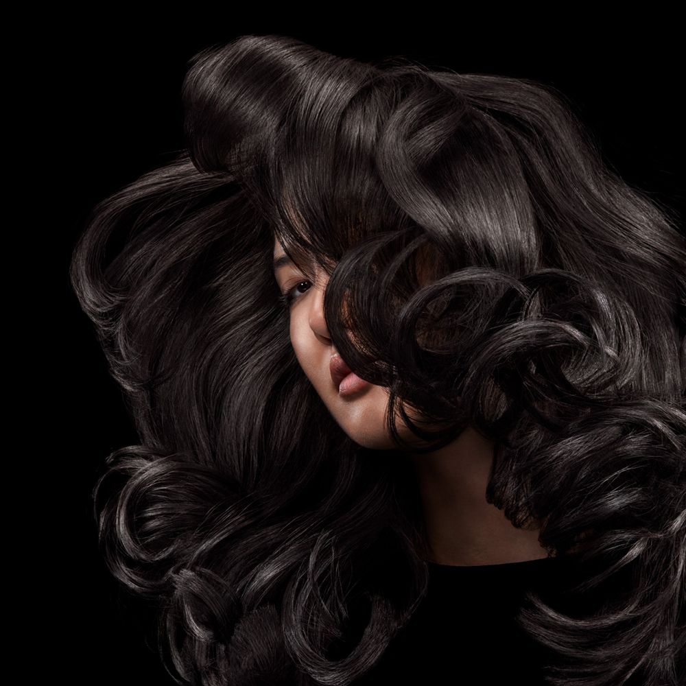 A model with long shiny black hair.