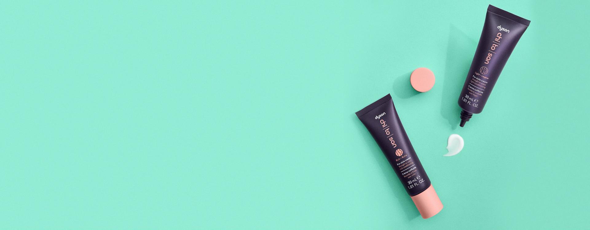 The Dyson Chitosan Pre-style cream range in 30ml sizes laid on a surface.