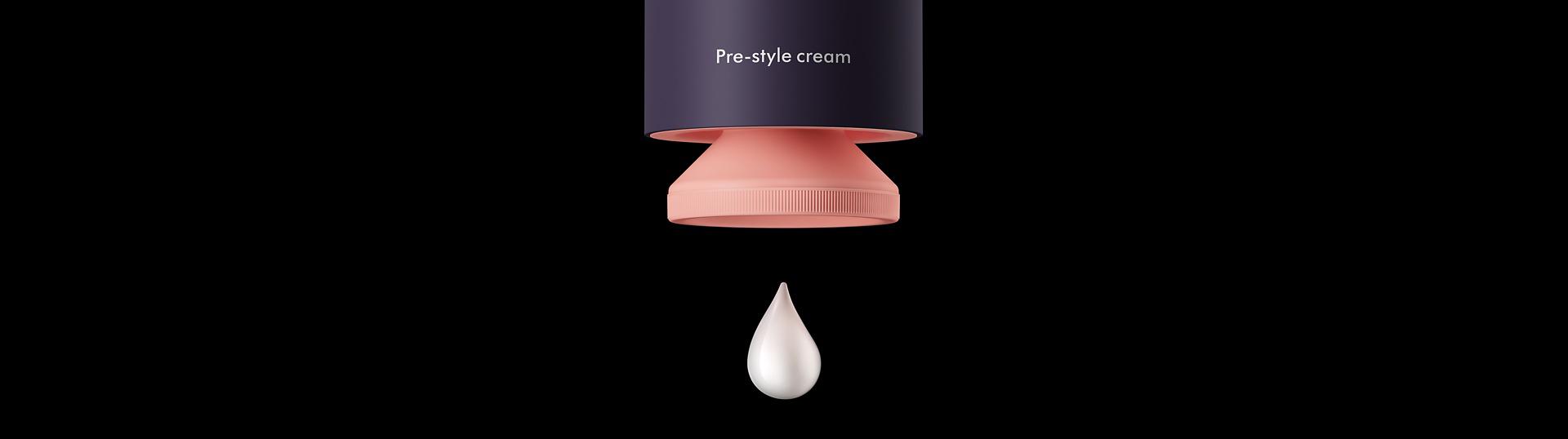 The Pre-style cream pump with a droplet of product, on a dark background.