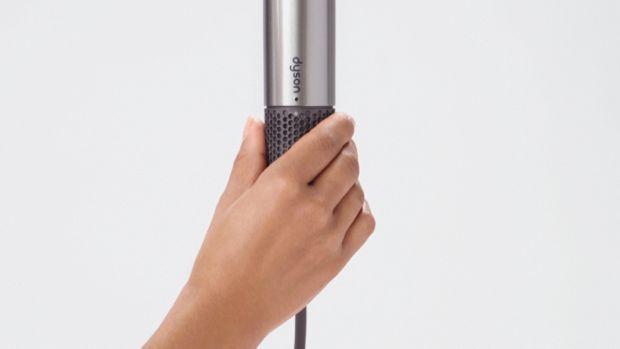 User's hand ready to remove filter cage.