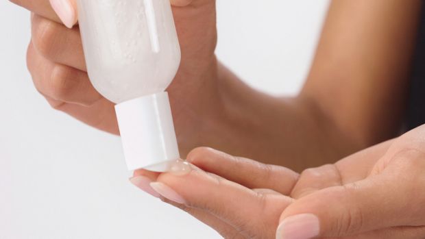 User squeezes clarifying shampoo bottle.