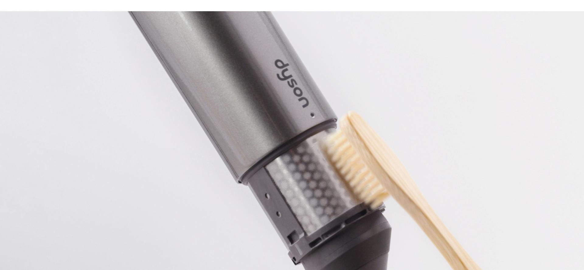 User brushes the styler's filter mesh.
