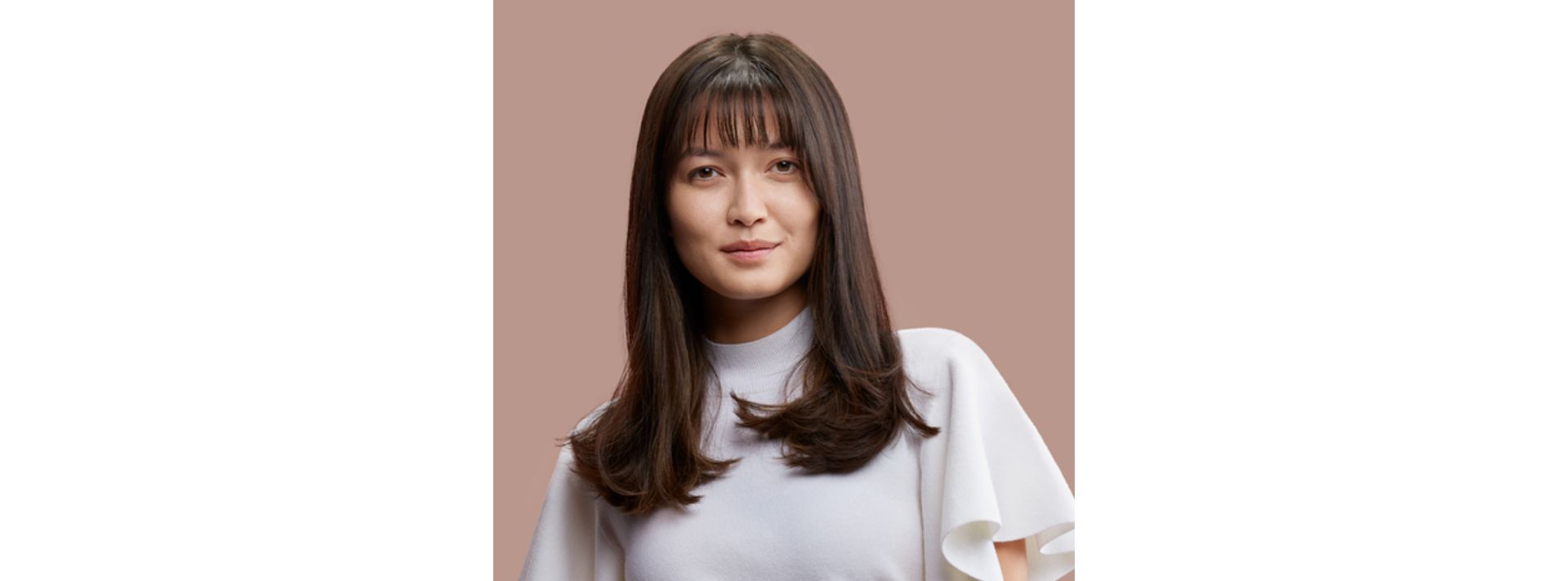 A model with dark hair styled with the Dyson Supersonic r hair dryer.