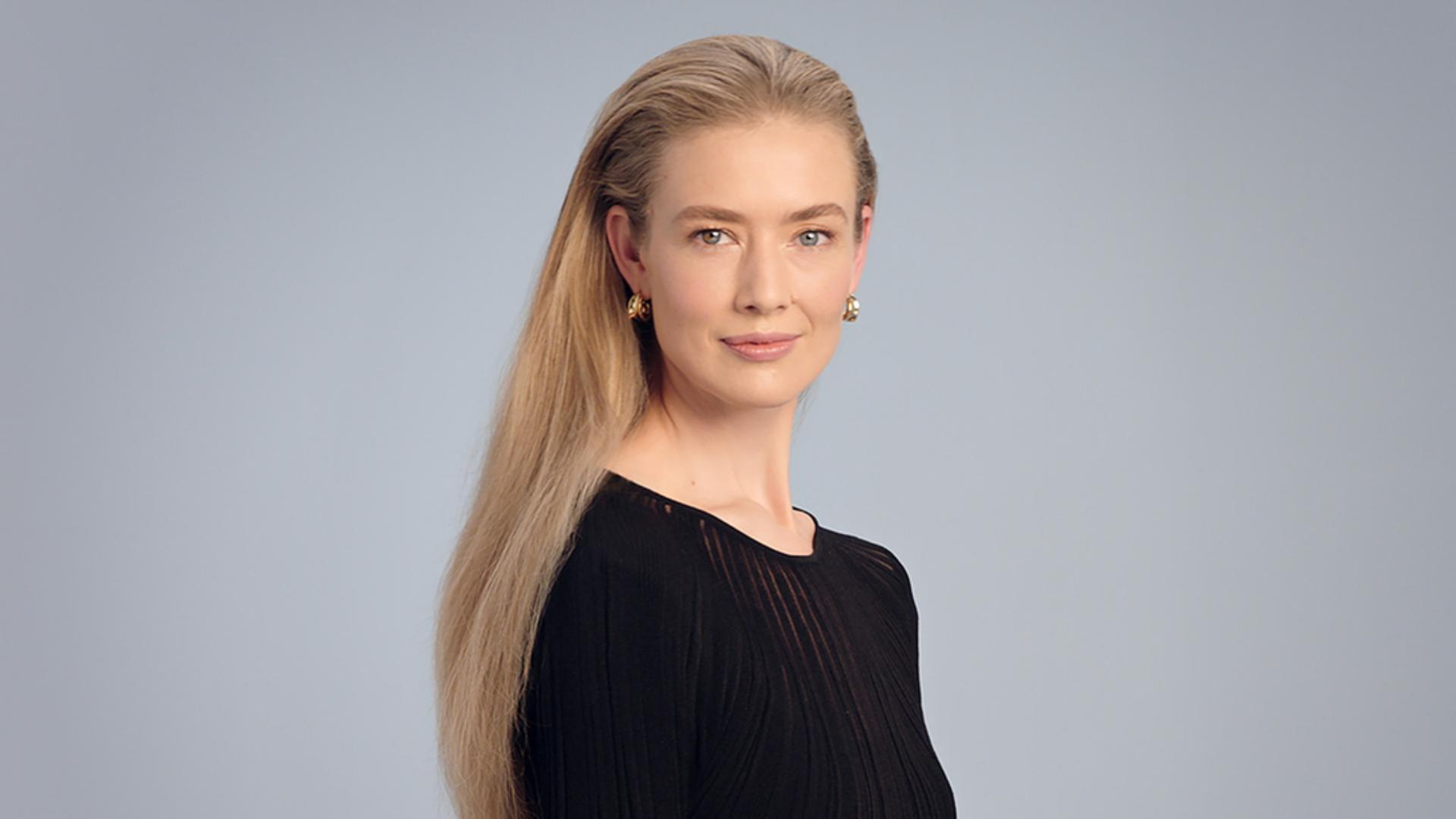 A blonde model with a smooth, straight hair style.