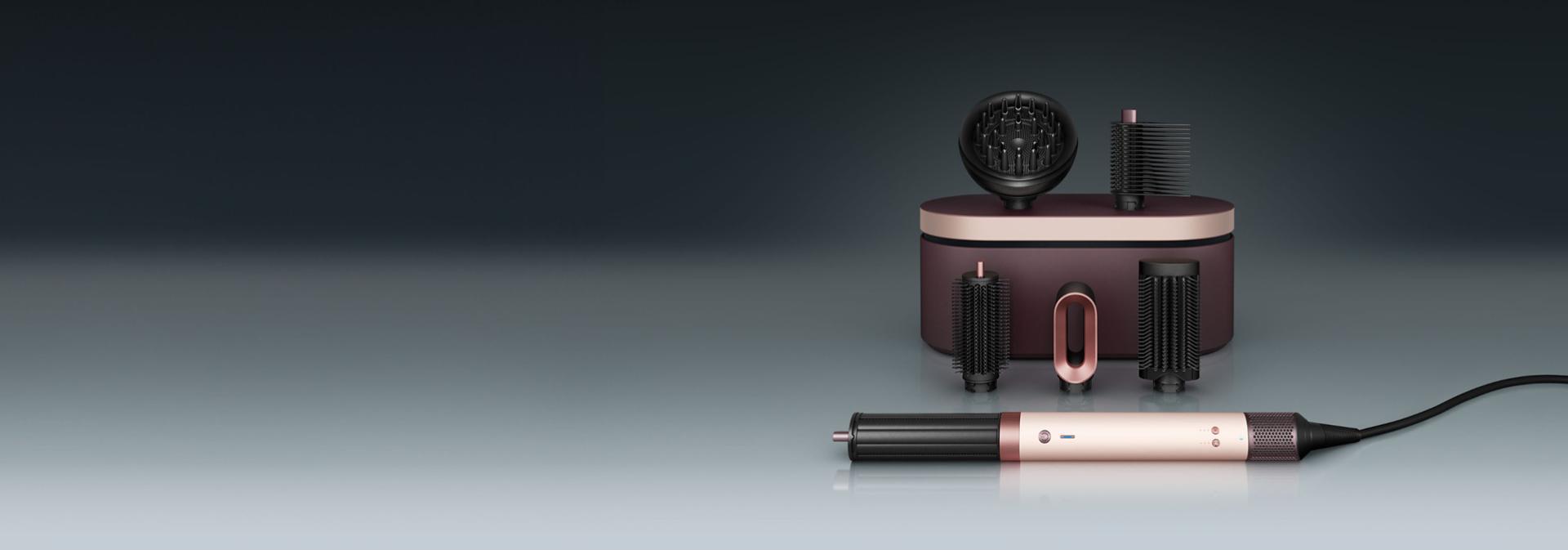 The Dyson Airwrap Co-anda2x multi-styler and dryer in front of a presentation case with a range of accessories.