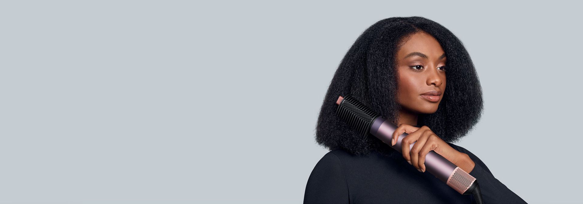 Multistyler Dyson Airwrap Co-anda2x z nowym grzebieniem napinającym włosy używany przez modelkę.