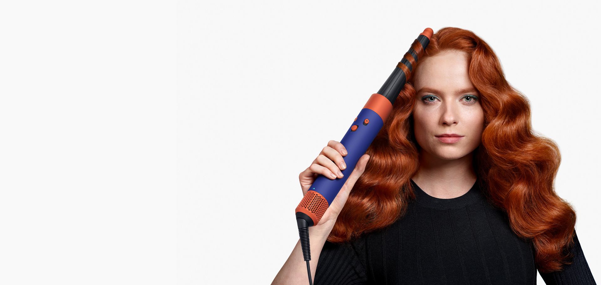 A model is curling her hair with an Airwrap ID multi-styler and dryer.