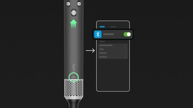 Dyson Airwrap i.d. daudzfunkcionālā matu ieveidošanas ierīce un žāvētājs līdzās viedtālrunim.