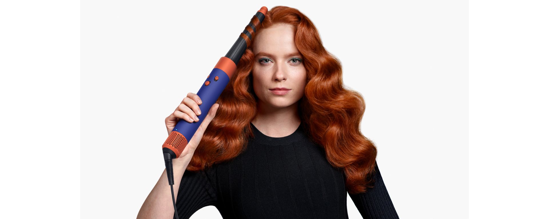 Model curling hair with a Dyson Airwrap i.d.