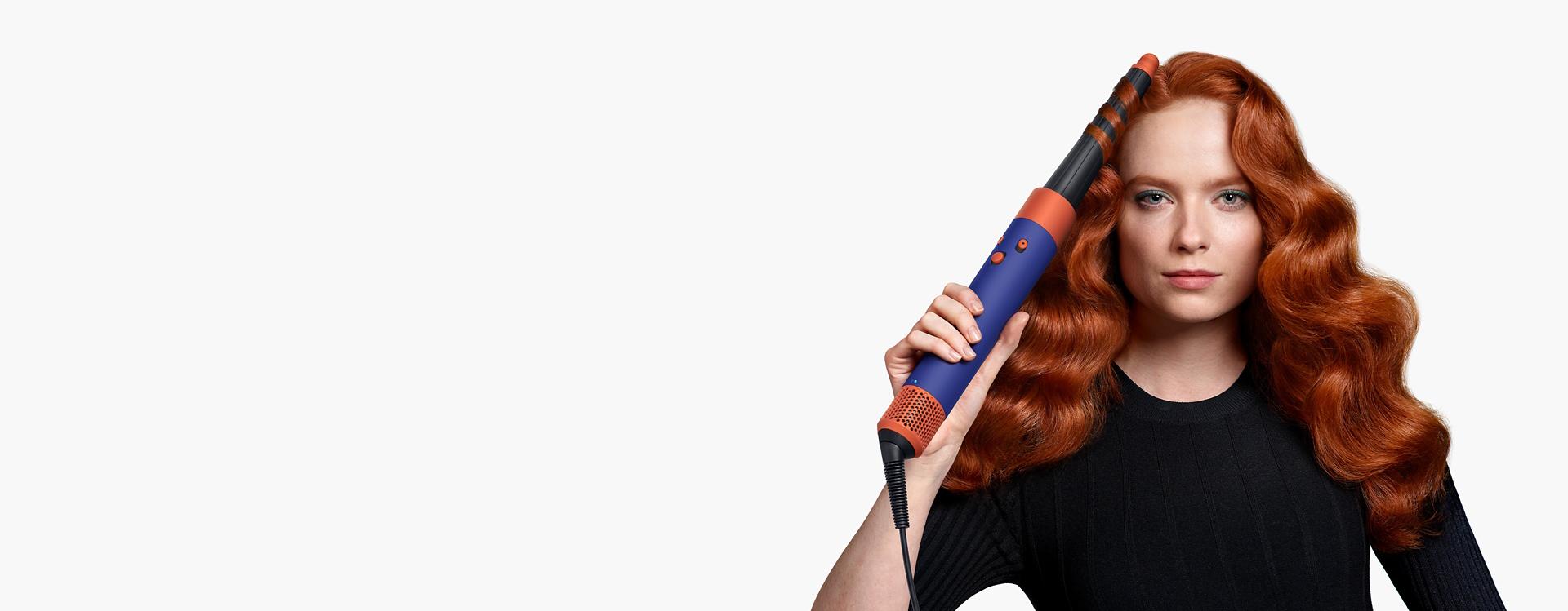 Model curling hair with the Conical Airwrap barrel.