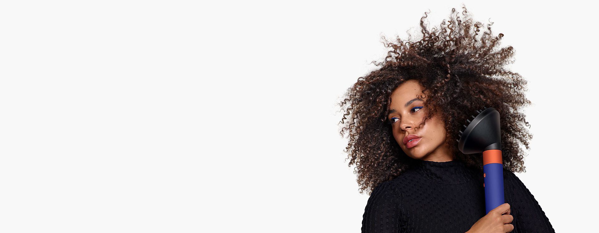 Model using the diffuser for the Dyson Airwrap multi-styler and dryer.