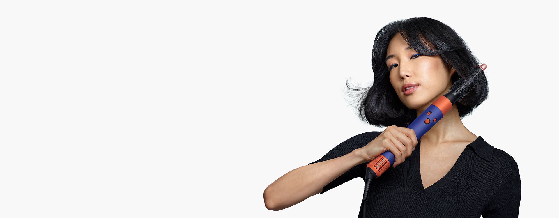 Model using the Small round volumising brush for the Dyson Airwrap multi-styler and dryer.