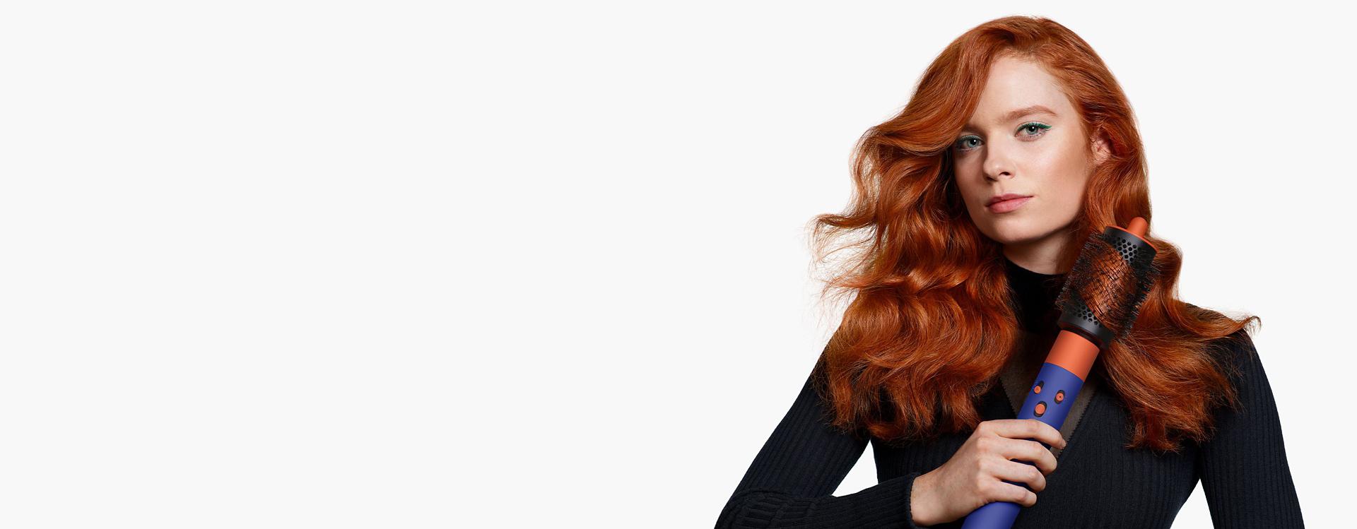 Model using the Large round volumising brush for the Dyson Airwrap multi-styler and dryer.