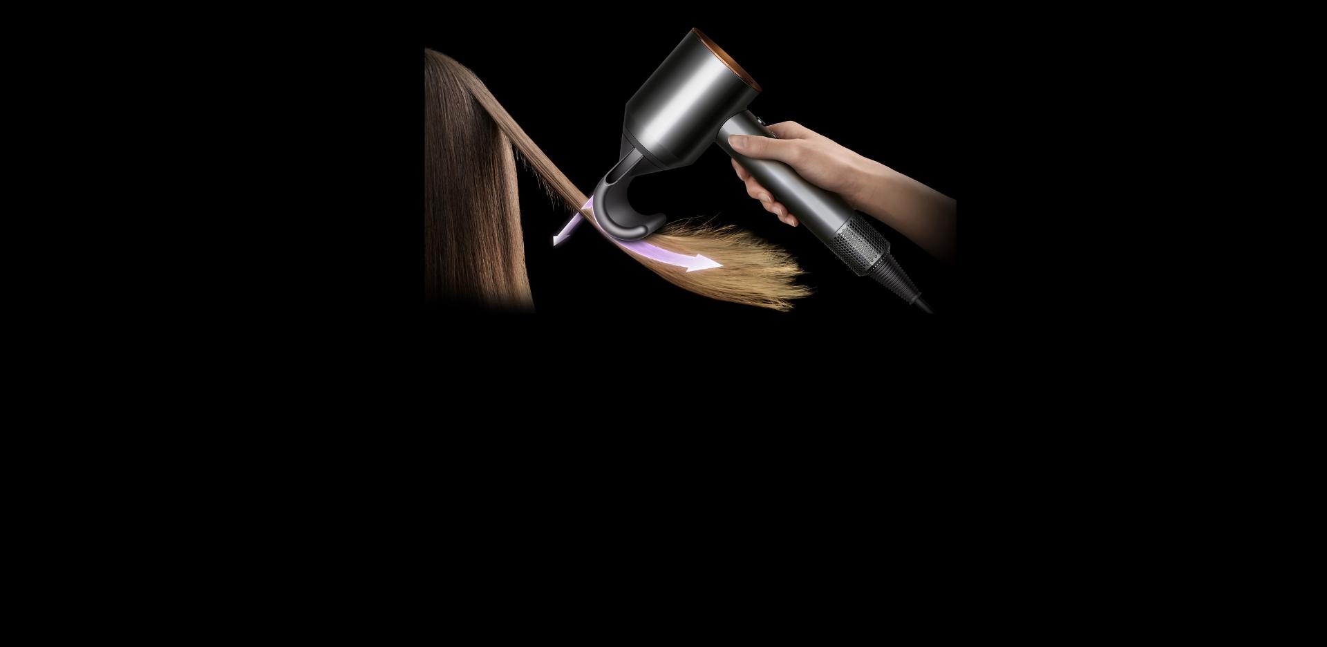A Dyson Supersonic hair dryer with the Flyaway attachment is used to hide flyaways on a model’s hair.