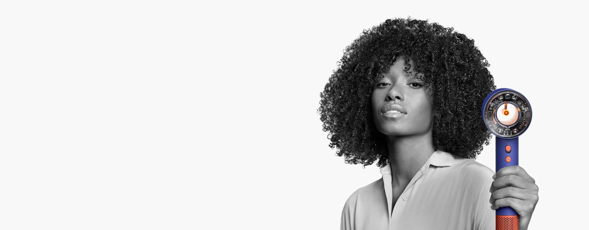 Female model using the Dyson Supersonic Nural hair dryer