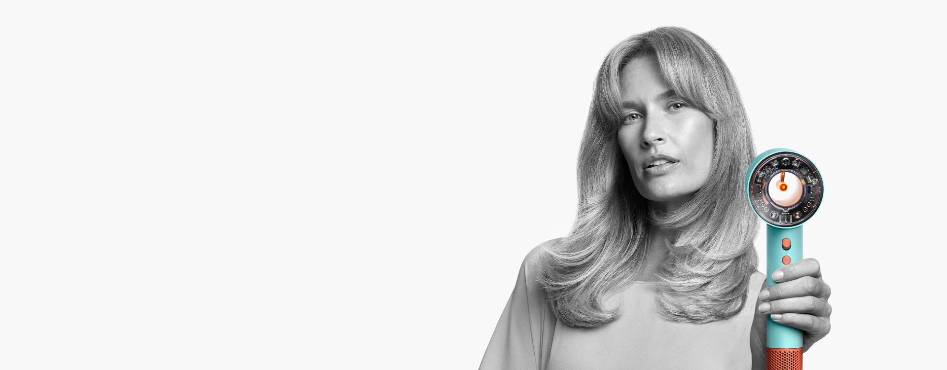 Female model using the Dyson Supersonic Nural hair dryer