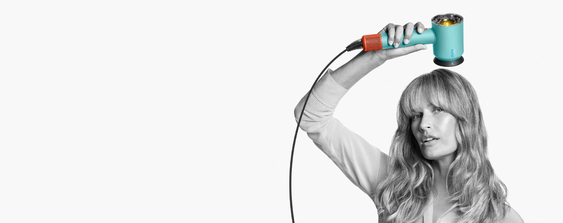 Female model using the Dyson Supersonic Nural hair dryer