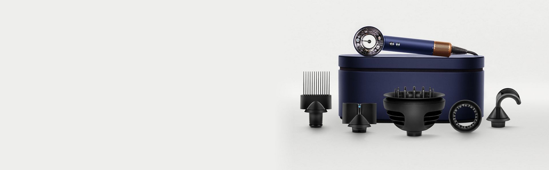 The Dyson Supersonic Nural hair dryer on a Presentation case behind a range of accessories.