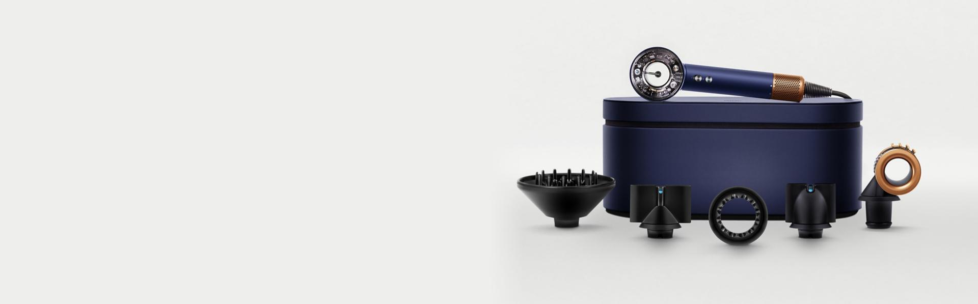 The Dyson Supersonic Nural hair dryer on a Presentation case behind a range of accessories.