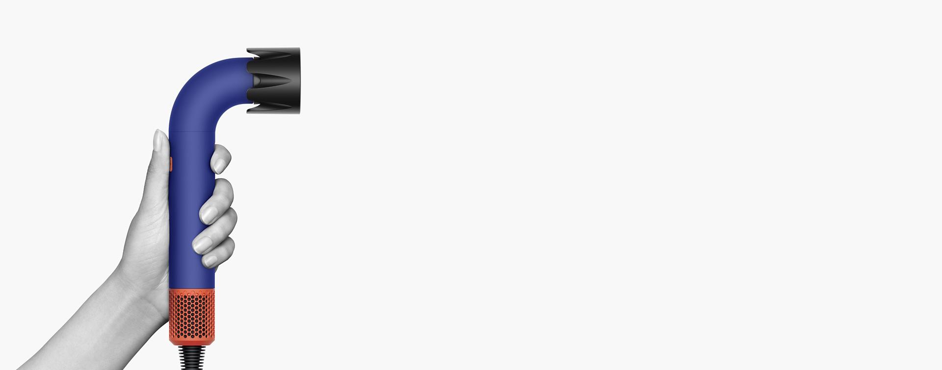 Hand holding the Dyson Supersonic r Professional hair dryer.