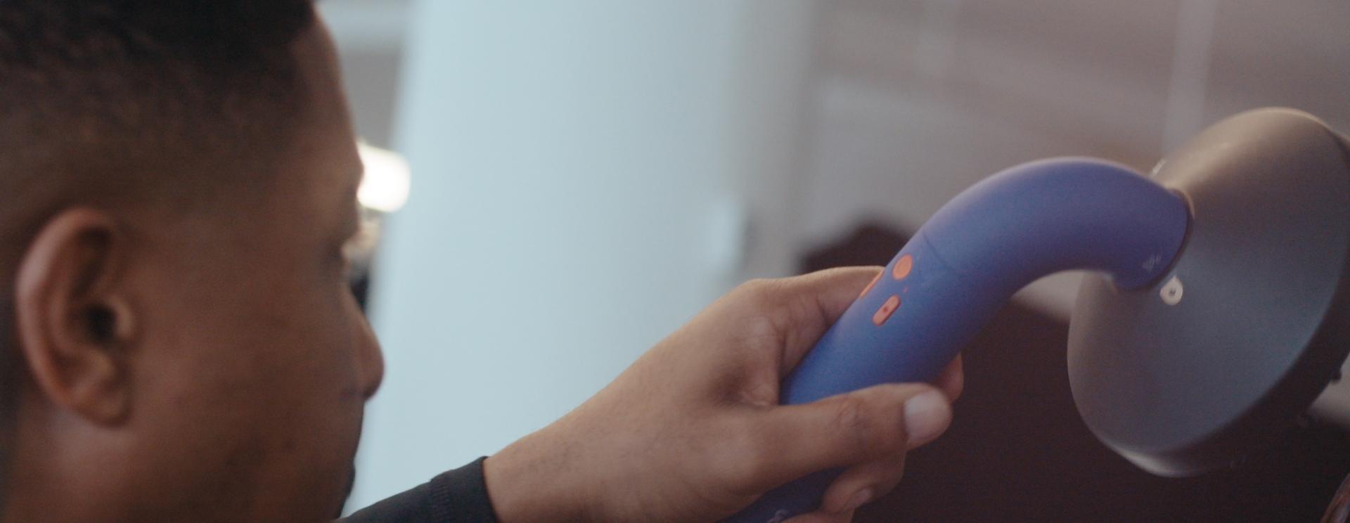 The Dyson Supersonic r hair dryer is used by a team of stylists to work on a model’s hair backstage at a fashion event.