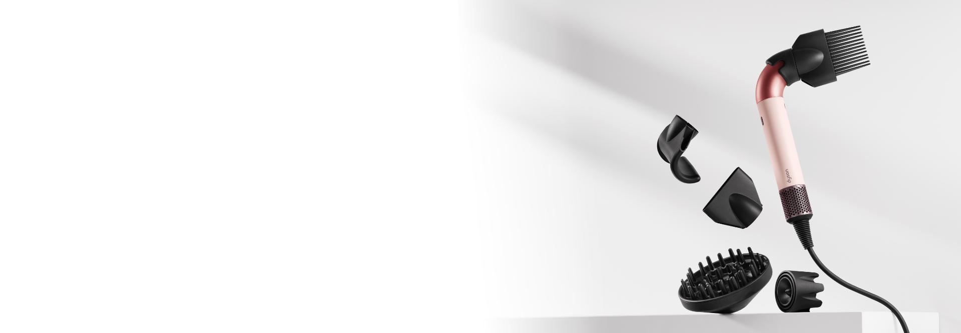 The Dyson Supersonic r hair dryer surrounded by a range of attachments.