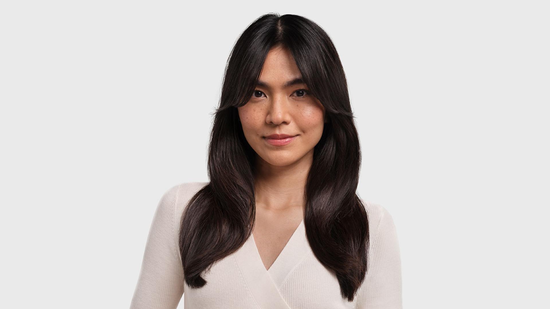 Model with Curtain bangs styled hair.