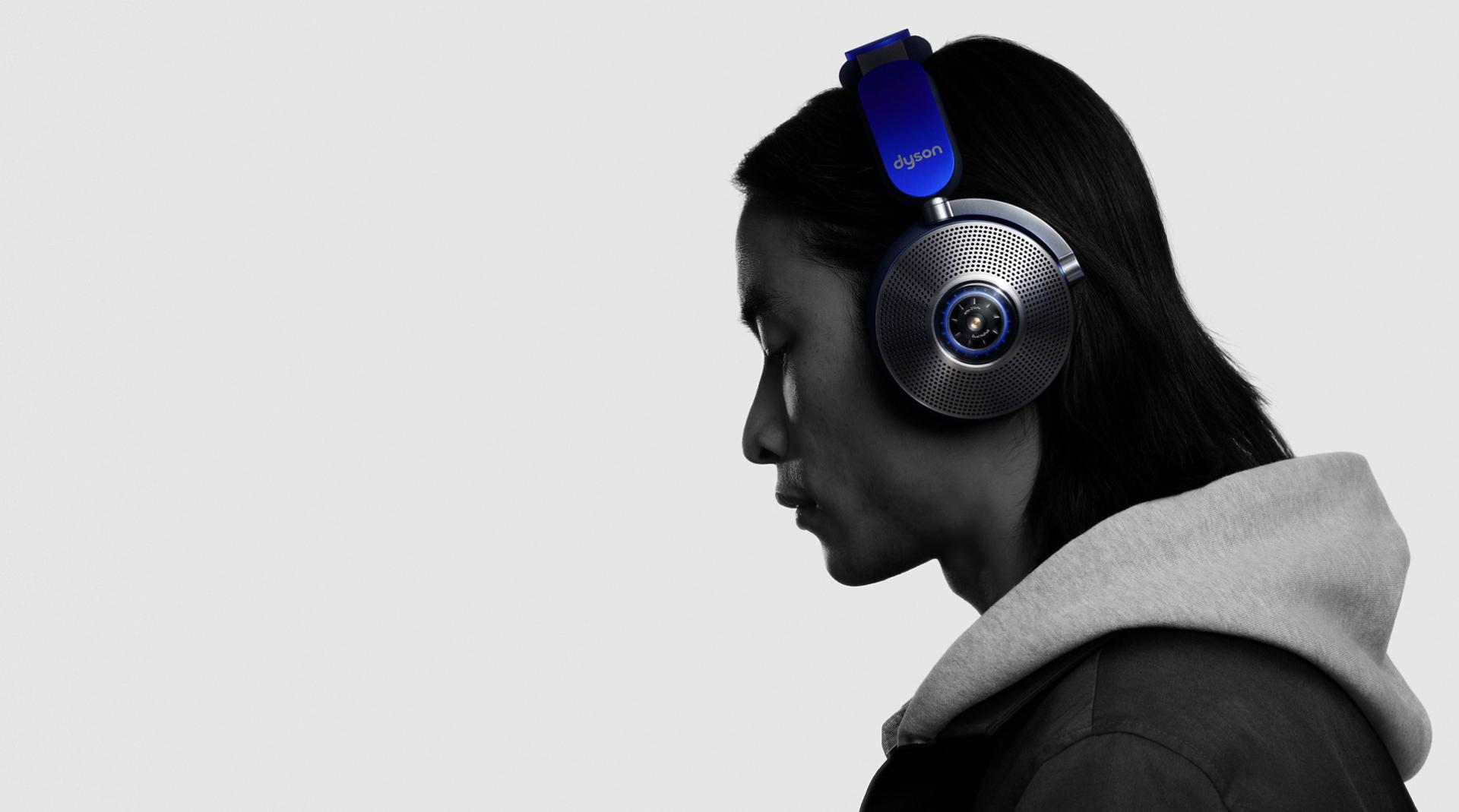 Side view of man wearing Dyson zone noise-cancelling headphones.