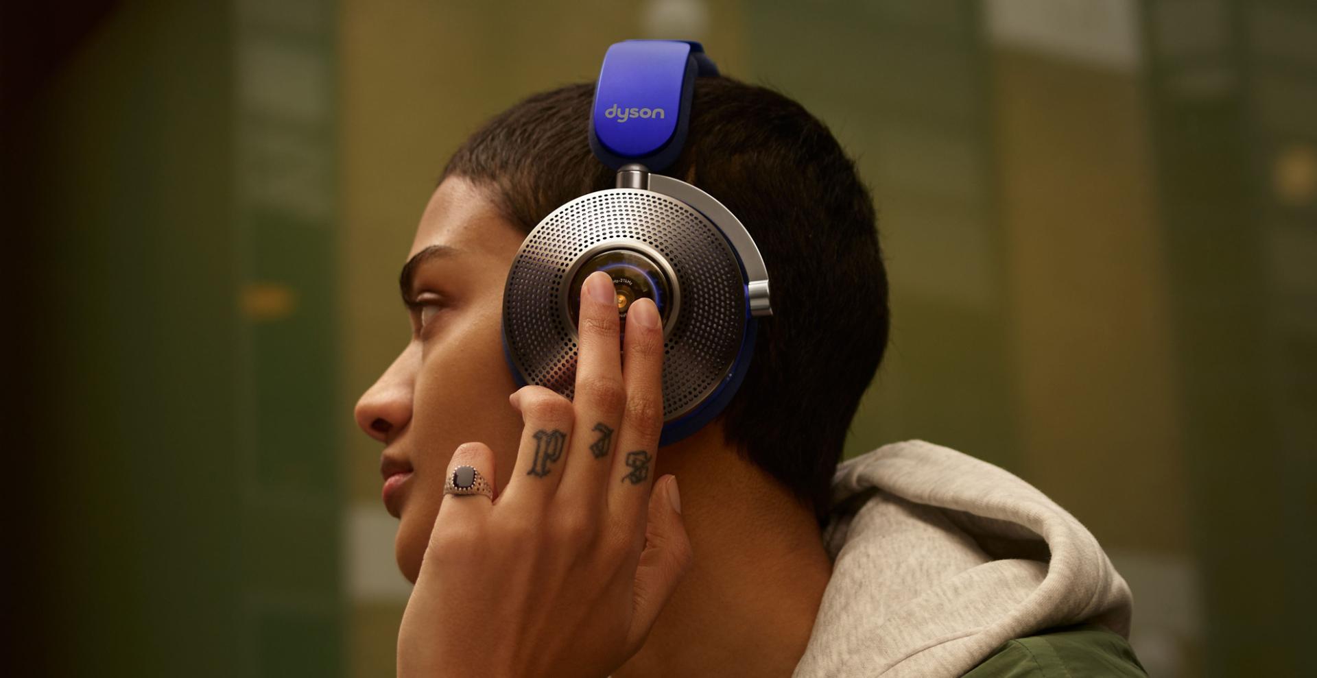 Woman wearing Dyson zone noise-cancelling headphones.