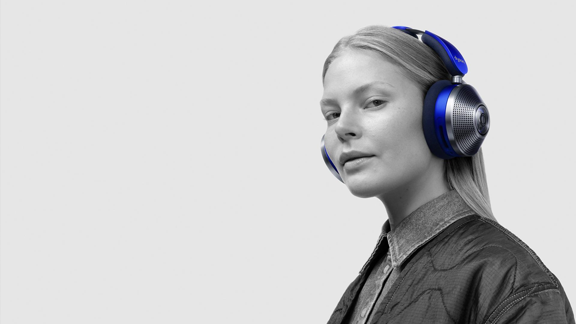 Woman wearing the Dyson Zone headphones with air purification. Arrows show the direction of airflow.