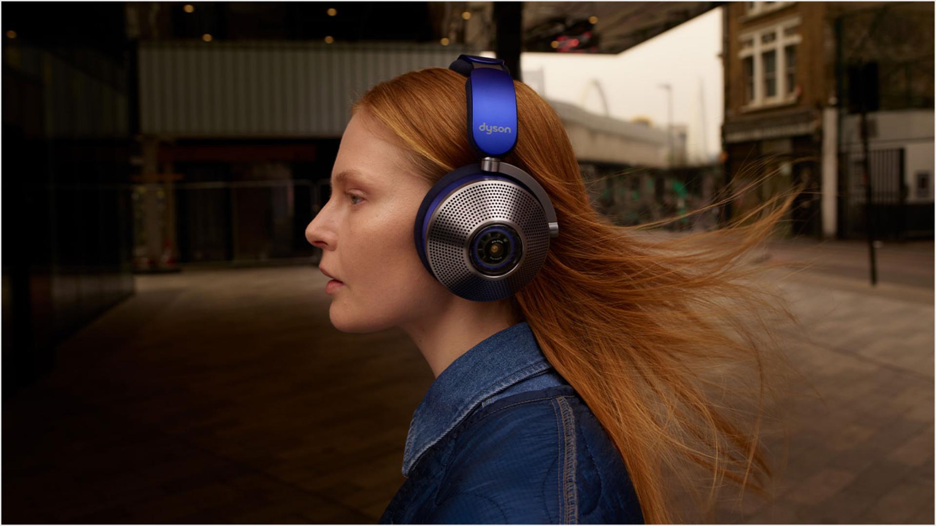 Side view of woman wearing Dyson zone noise-cancelling headphones.