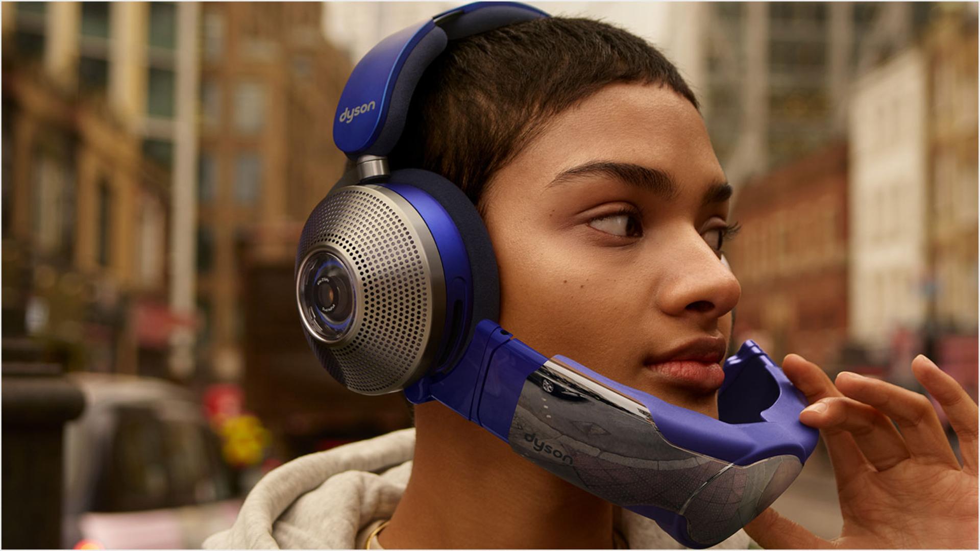 Woman wearing Dyson Zone headphones with air purification in Conversation mode with the visor flipped down. 