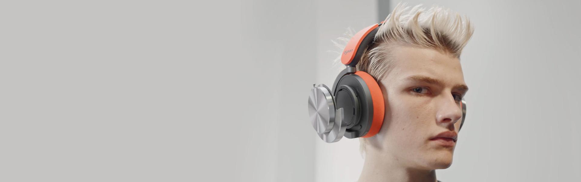 A model wearing the Dyson OnTrac headphones.