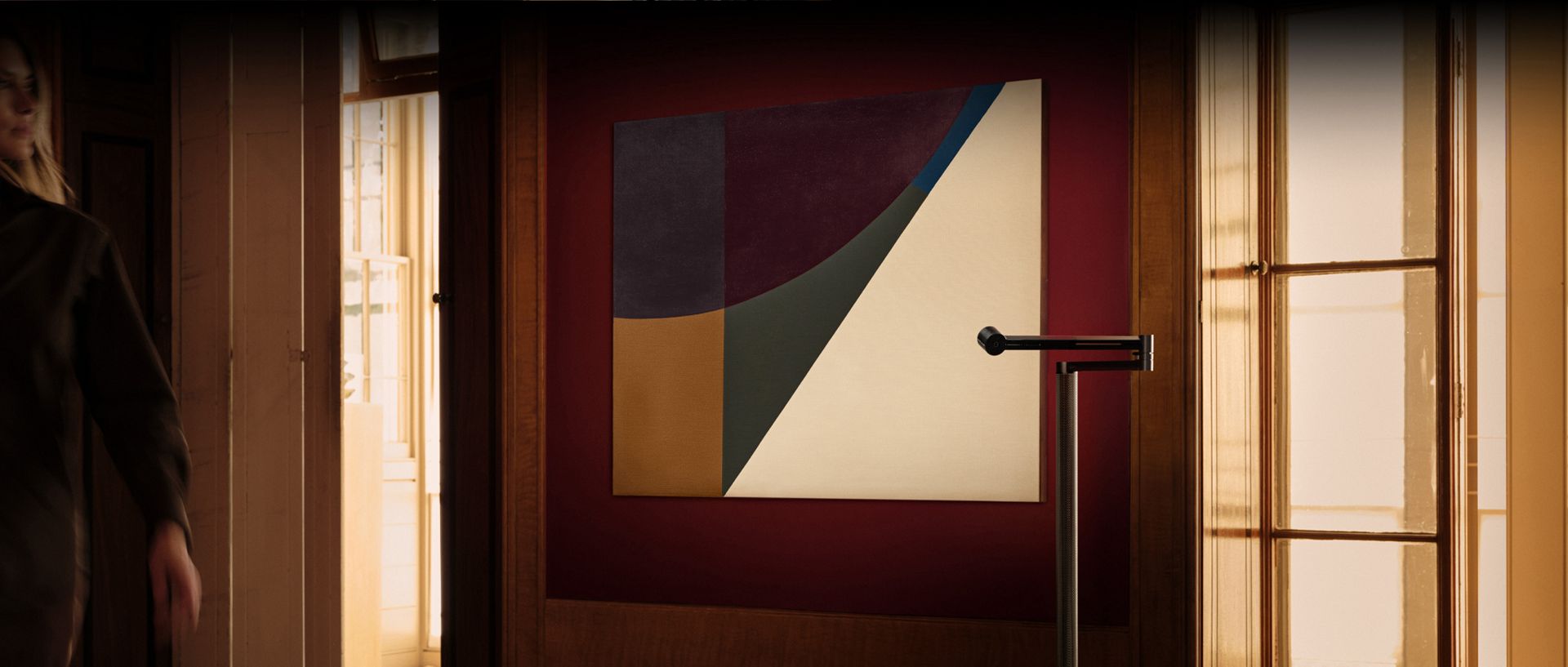 Dyson Solarcycle Morph floor light showcasing a piece of art on the wall.