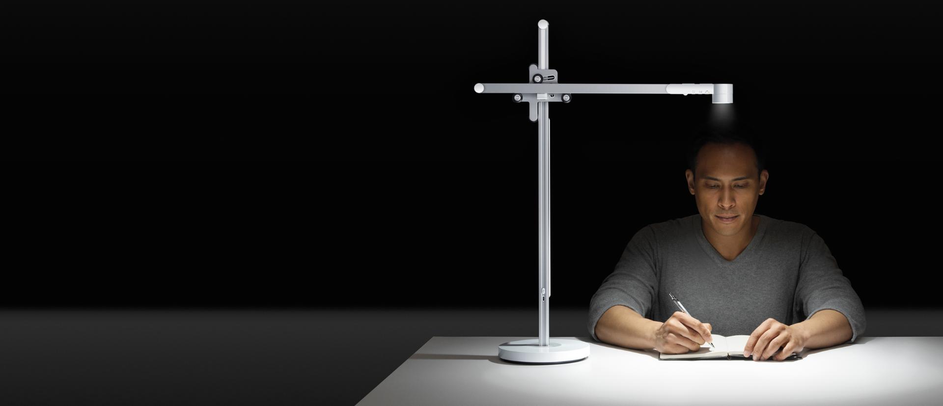 Man working under the Dyson Lightcycle task light
