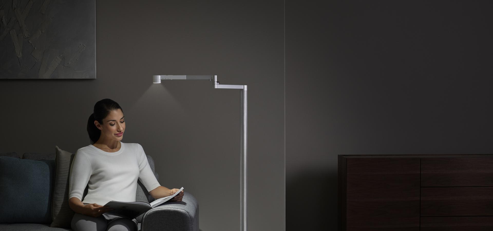 Woman working under task light from the Dyson Lightcycle Morph light