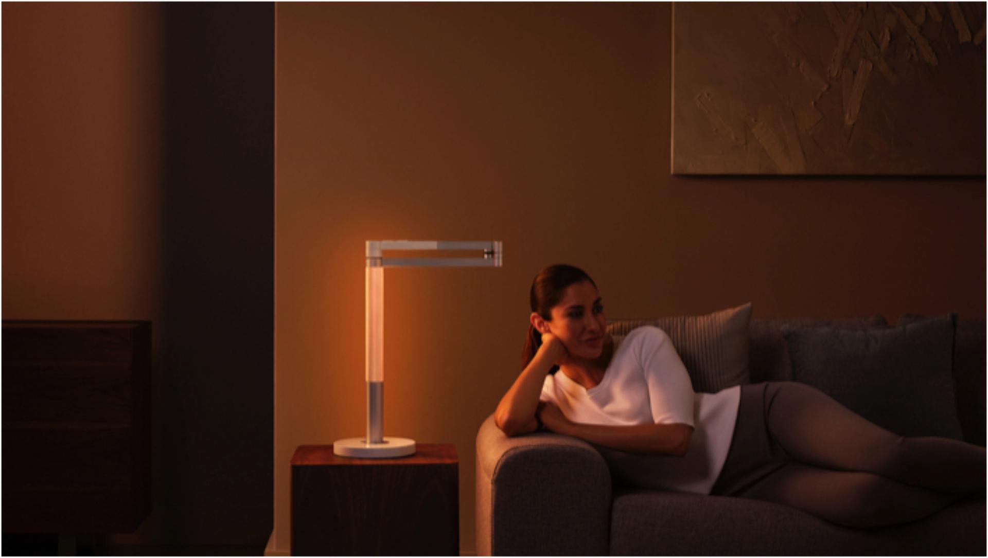 Woman working under the Dyson Lightcycle Morph light in Ambient position