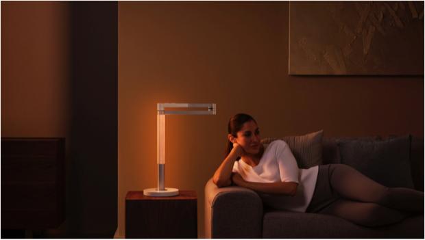 Woman working under the Dyson Lightcycle Morph light in Ambient position