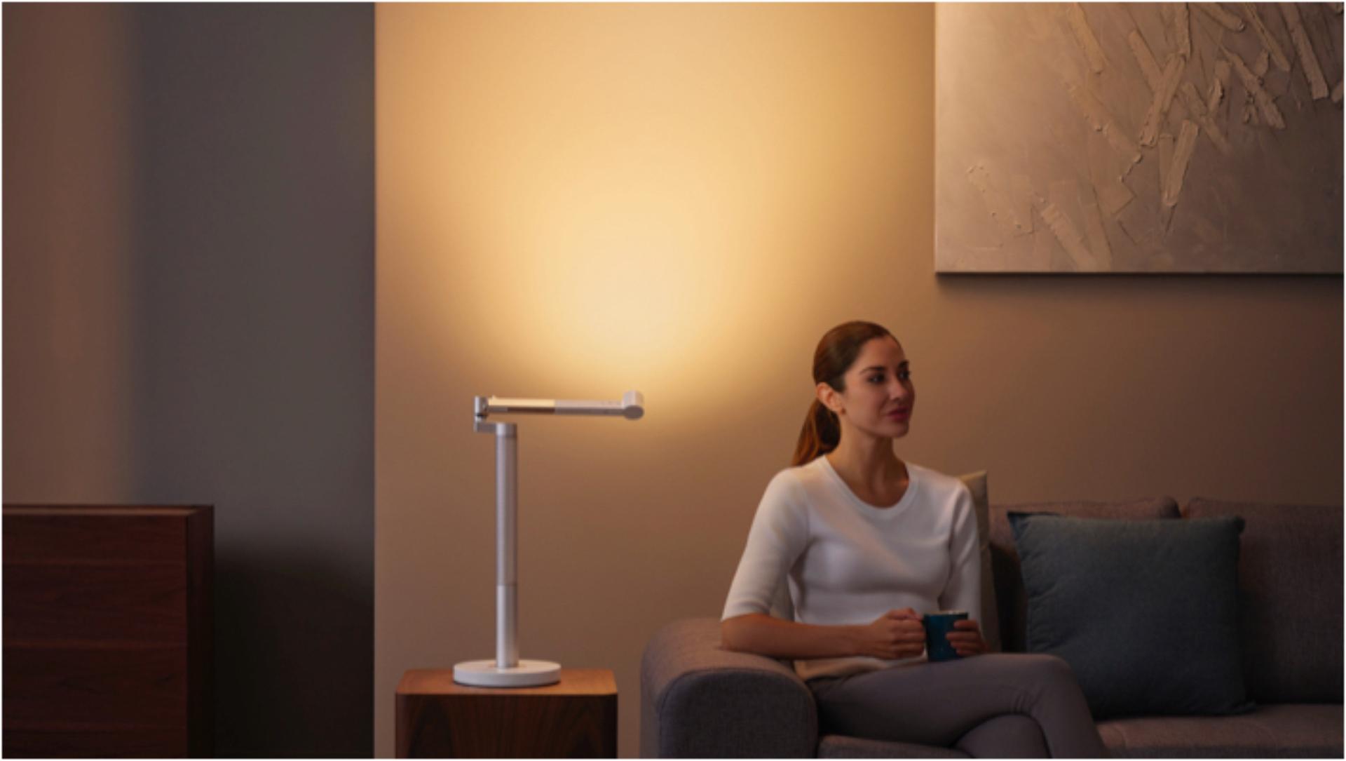 Woman working under the Dyson Lightcycle Morph light in Indirect position