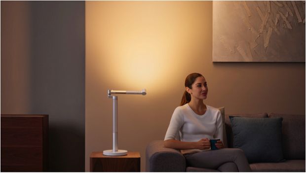 Woman working under the Dyson Lightcycle Morph light in Indirect position
