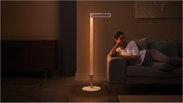 Woman working under the Dyson Lightcycle Morph light in Ambient position