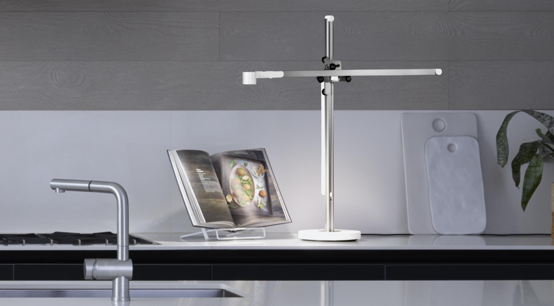 Dyson Lightcycle task light illuminating a recipe book in the kitchen
