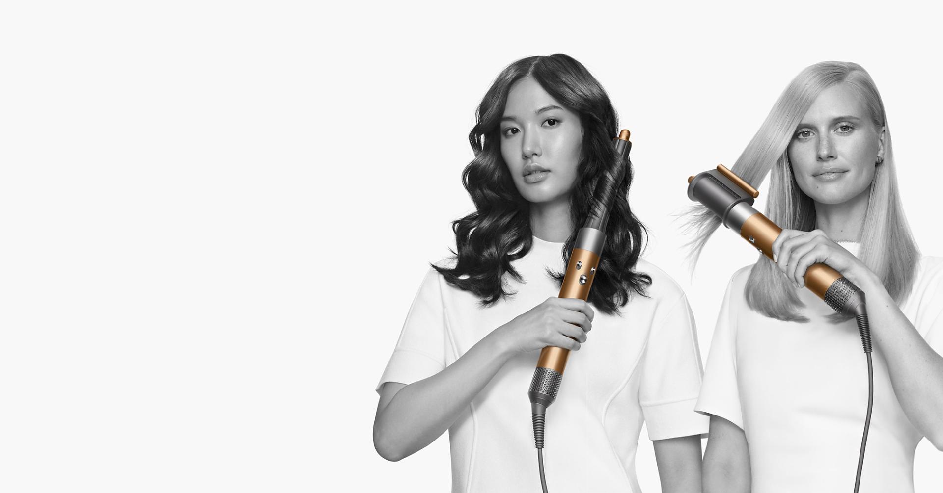 Model using a Dyson Airwrap to curl her hair
