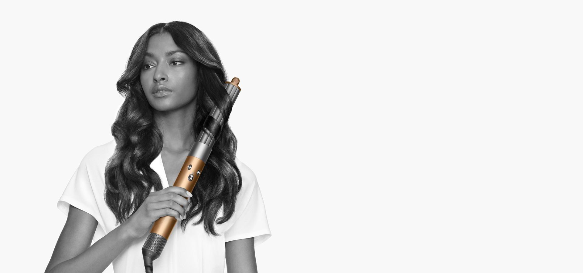 عارِضة تَستخدم جهاز Dyson Airwrap مع ملحق الفرشاة