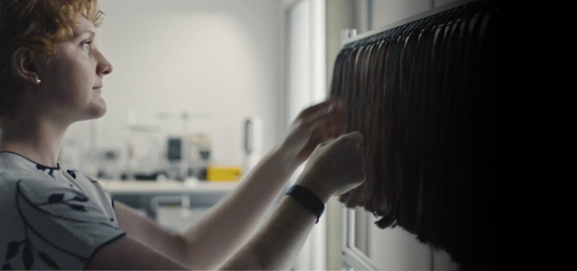 عالمة شعر بينما تعمل على الخصلات في أحد المختبرات